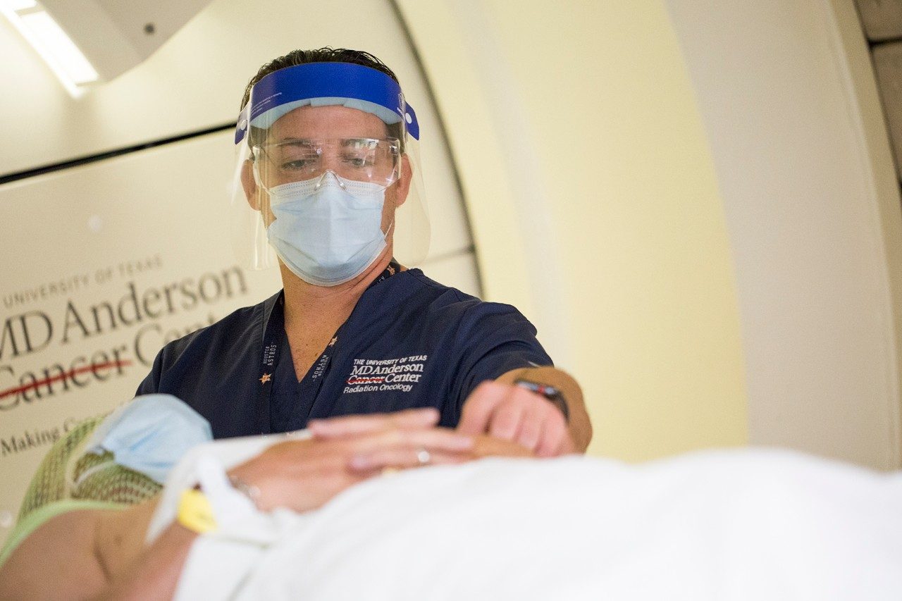 Clinical radiation therapy supervisor Chris Sanders, administers proton therapy to a head and neck cancer patient.