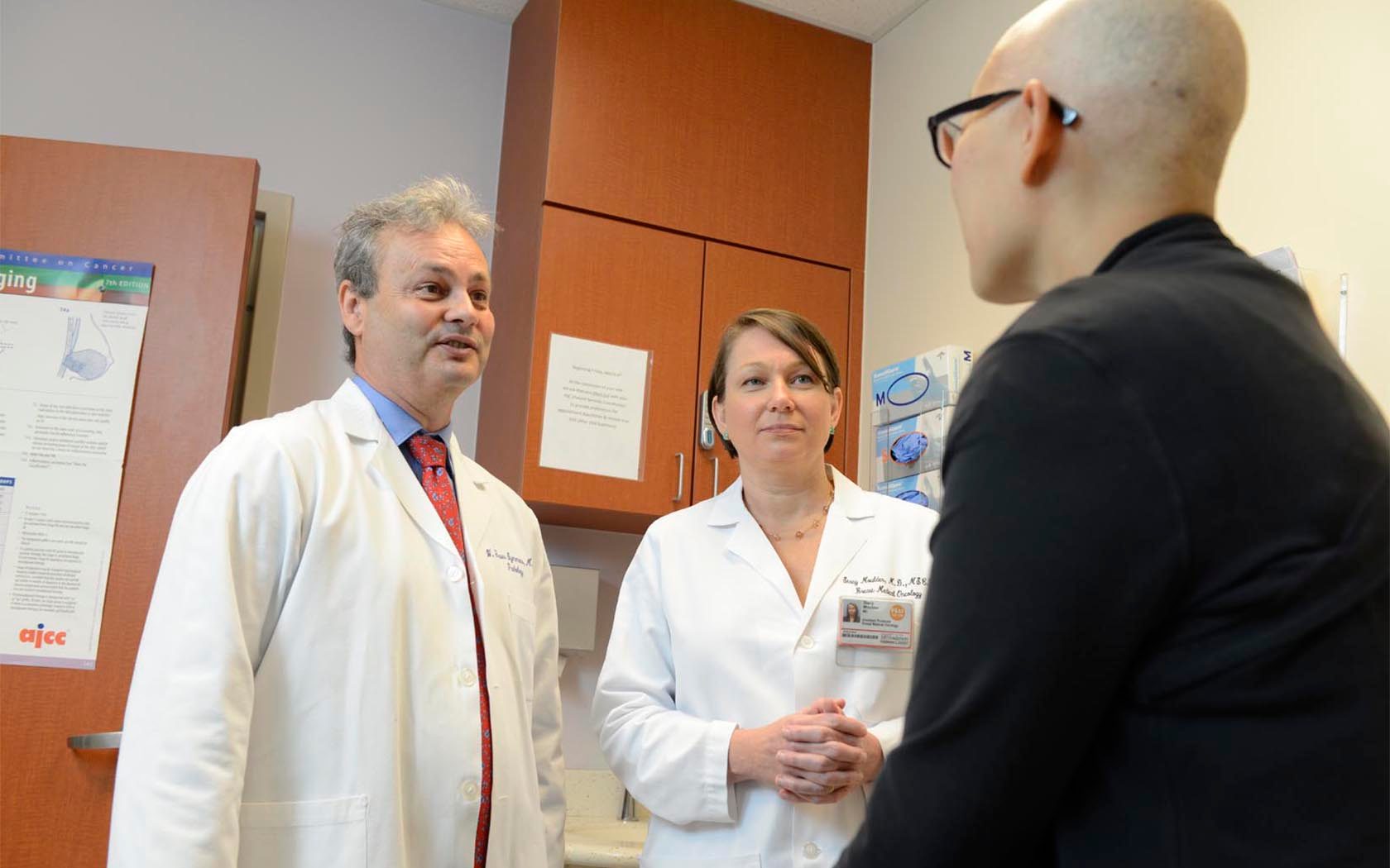 W. Fraser Symmans, M.D., and Stacy Moulder, M.D. with patient Janine Blackwell
